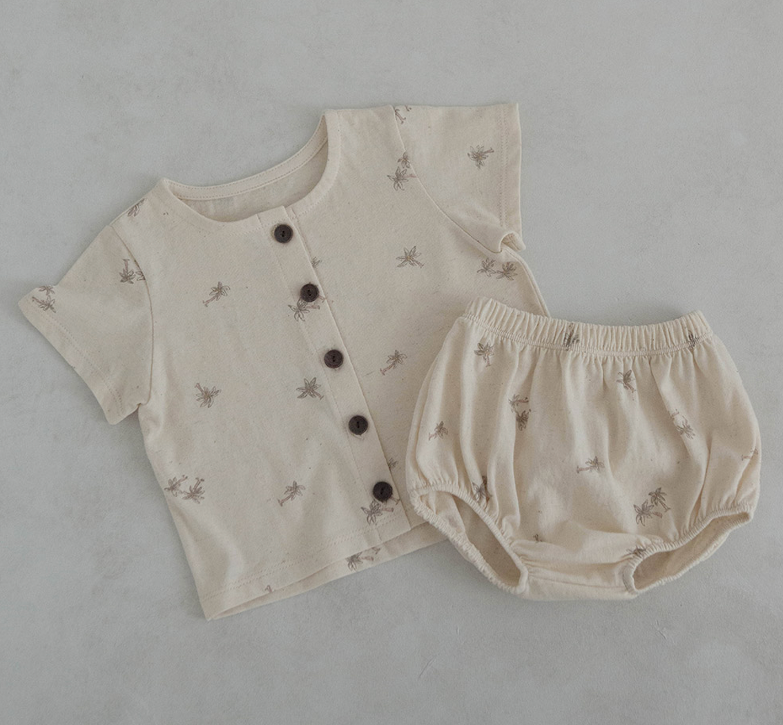 light oatmeal colored cotton baby tshirt and bloomer set adorned with wooden buttons and palm tree decals