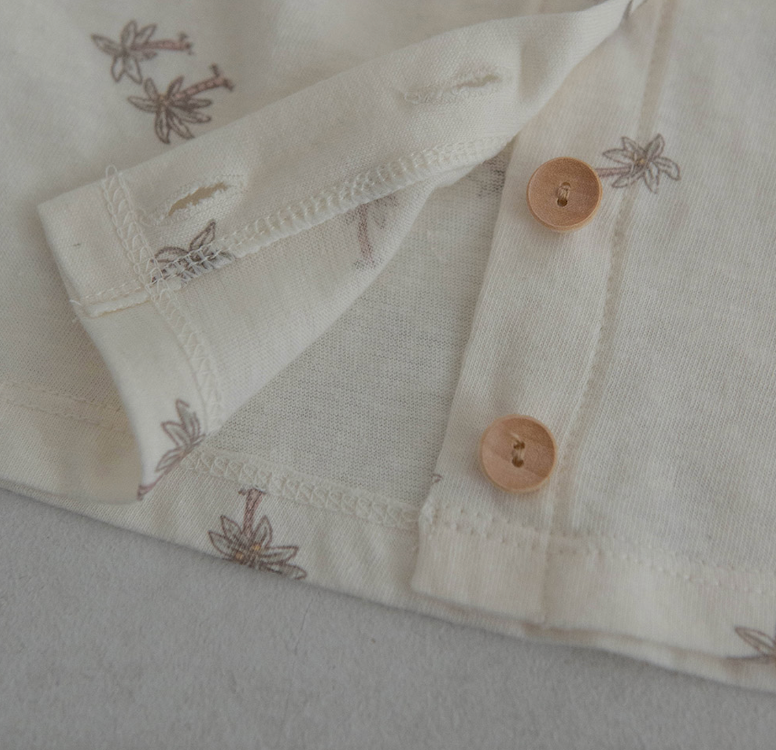 light ivroy colored cotton baby tshirt and bloomer set adorned with wooden buttons and palm tree decals